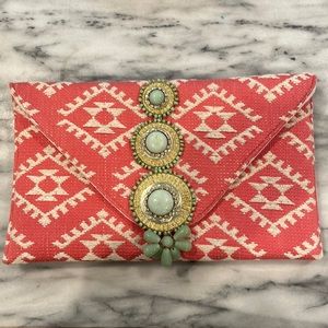 Pink and green woven clutch